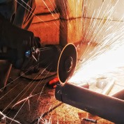 Industrial angle grinder cutting metal with abrasive disc – sparks flying – Jones & Clark trade abrasives guide
