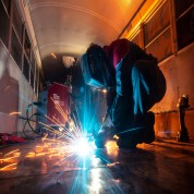 Welder using industrial welding equipment with sparks flying – supplied by Jones & Clark in Burton.